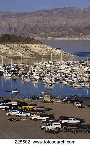Stock Image - Boats moored at marina in bay, Lake Mead Marina, Nevada, USA . Fotosearch