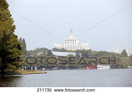Building surrounded by trees, Lake Herastrau, Casa Presei Libere, Bucharest, Romania View Large Photo Image Stock Photography - Building surrounded by trees, Lake Herastrau, Casa Presei Libere, Bucharest, Romania . Fotosearch
