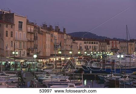 Stock Photo - Buildings at port at dusk, St. Tropez, Provence-Alpes-Cote d'Azur, France . Fotosearch