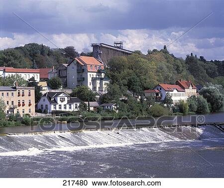 Stock Image - Buildings at waterfront, River Saale, Bad Koesen, Saxony-Anhalt, Germany . Fotosearch