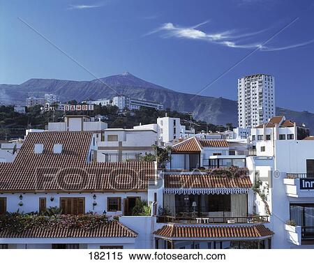 Stock Photography - Buildings in city against mountain range, Puerto De La Cruz Tenerife, Canary Islands, Spain . Fotosearch
