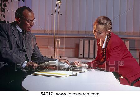 Businessman and businesswoman reading document View Large Photo Image Stock Image - Businessman and businesswoman reading document . Fotosearch