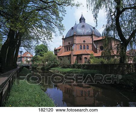 Canal flowing besides church in town, Lower Saxony, Germany View Large Photo Image Stock Image - Canal flowing besides church in town, Lower Saxony, Germany . Fotosearch