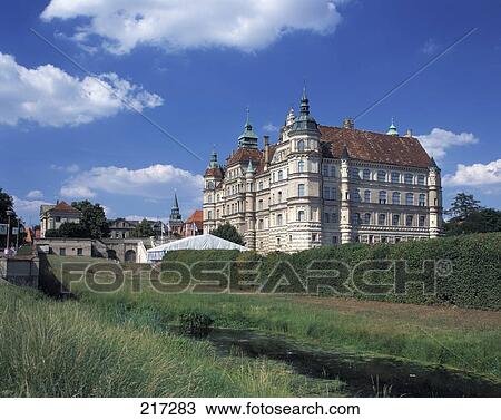 Stock Image - Canal flowing in front of castle . Fotosearch