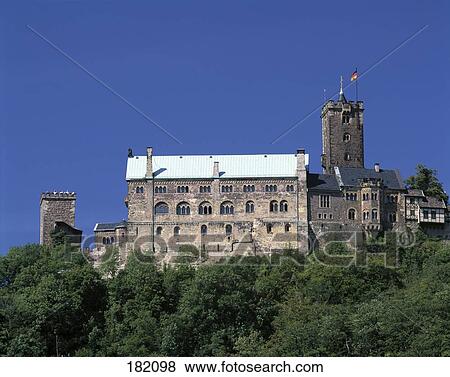 Stock Photo - Castle on hill against blue sky, Wartburg Castle, Thuringia, Germany . Fotosearch