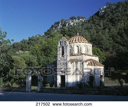 Stock Image - Church near hill, Agios Nikolaos Church, Rhodes, Dodecanese Islands, Greece . Fotosearch