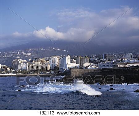 City at coast under overcast sky, Puerto De La Cruz Tenerife, Canary Islands, Spain View Large Photo Image Stock Image - City at coast under overcast sky, Puerto De La Cruz Tenerife, Canary Islands, Spain . Fotosearch