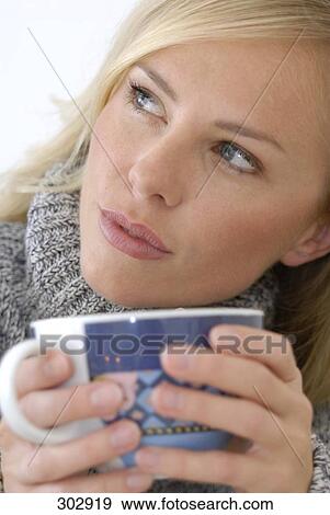 Close-up of mid adult woman holding cup of tea View Large Photo Image Stock Photo - Close-up of mid adult woman holding cup of tea . Fotosearch