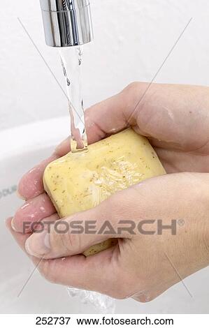 Stock Photo - Close-up of woman washing her hands with soap . Fotosearch
