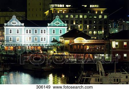 Stock Photo - Coffeehouse lit up at night, Hildebrand Restaurant, Victoria and Albert Waterfront, Cape Town, Western Cape, South Africa . Fotosearch