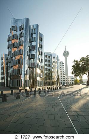 Stock Photo - Communication tower and buildings in city, Rhein Tower, Gehry Buildings, Dusseldorf, North Rhine-Westphalia, Germany . Fotosearch