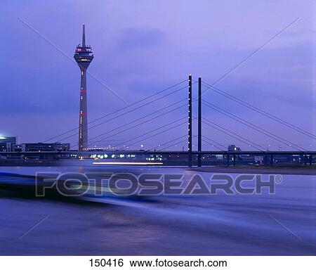 Communication tower and suspension bridge lit up at night, Oberkasseler Bridge, Düsseldorf, Germany View Large Photo Image Stock Photograph - Communication tower and suspension bridge lit up at night, Oberkasseler Bridge, Düsseldorf, Germany . Fotosearch