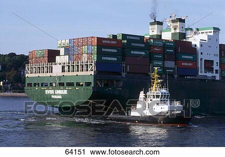 Stock Image - Container ship and tugboat in sea, Hamburg, Germany . Fotosearch