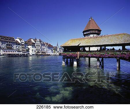 Stock Photography - Covered bridge across lake, Chapel Bridge, Vierwaldstaetter Lake, Switzerland . Fotosearch
