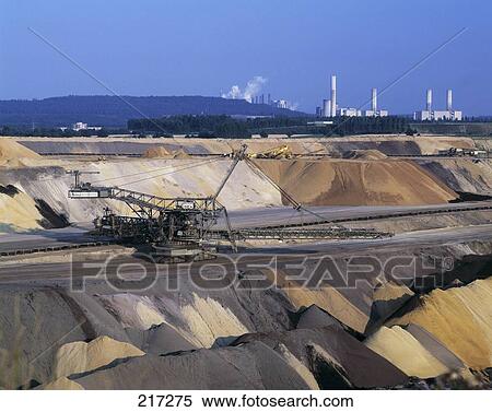 Stock Photography - Crane at construction site with power plant in background . Fotosearch