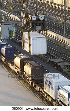 Cranes loading freight train with cargo container, Hamburg, Germany View Large Photo Image Stock Image - Cranes loading freight train with cargo container, Hamburg, Germany . Fotosearch