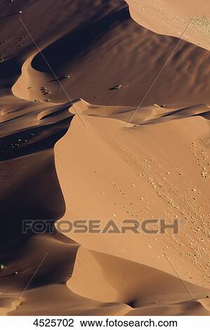Stock Image - Crest of a red sand dune at Sossusvlei in Naukluft National Park, Namib Desert, Namibia . Fotosearch