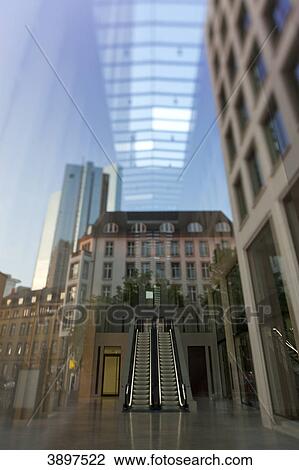 Stock Image - Deutsche Bank Twin Towers mirroring in glass fade,, Frankfurt am Main, Germany . Fotosearch