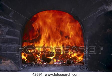 Firewood burning in fireplace at open air museum, France View Large Photo Image Stock Image - Firewood burning in fireplace at open air museum, France . Fotosearch