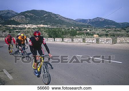 Four mountain bikers on a road View Large Photo Image Stock Image - Four mountain bikers on a road . Fotosearch
