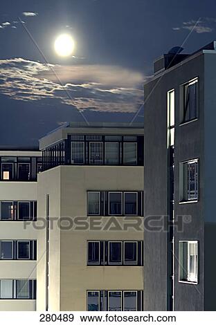 Stock Photo - Full moon over city . Fotosearch