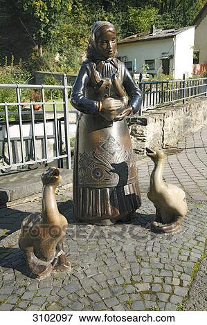 Stock Photo - Girl with goose, ceramic figures . Fotosearch