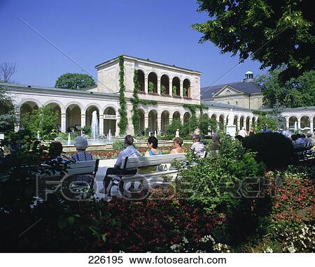 Stock Photography - Group of people sitting in park benches, Bath Kissingen, Franconia, Germany . Fotosearch