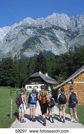 Stock Photo - Group of tourists with backpacks,, Alps Mountain Range, Germany, Europe . Fotosearch