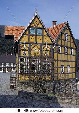 Stock Photo - Half timbered house through hedge, Germany . Fotosearch