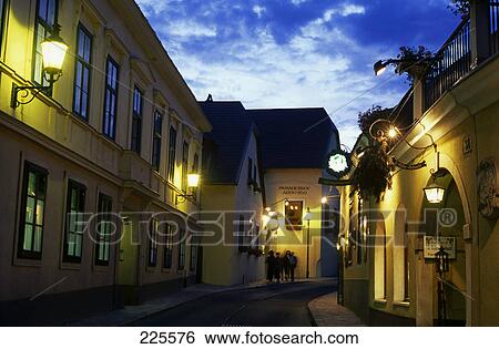 Stock Photograph - Heurigen pubs lit up at dusk, Vienna, Austria . Fotosearch
