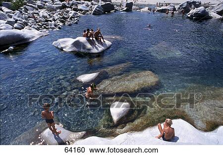 Stock Image - High angle view of children in river, Tessin, Switzerland . Fotosearch