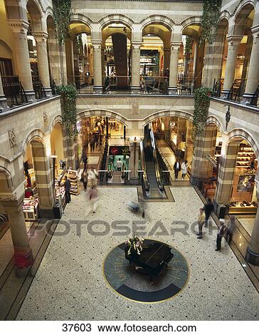 Stock Image - High angle view of people in shopping center, Magna Plaza, Amsterdam, Netherlands . Fotosearch