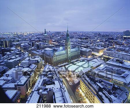 Stock Photo - High angle view of snow on rooftop of buildings in city, Hamburg, Germany . Fotosearch