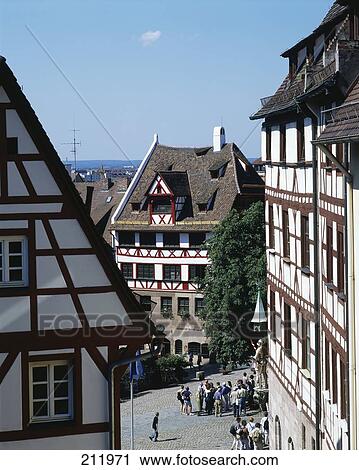 Stock Image - High angle view of tourists near timber framed house, Albrecht Duerer House Museum, Nueremberg, Germany . Fotosearch