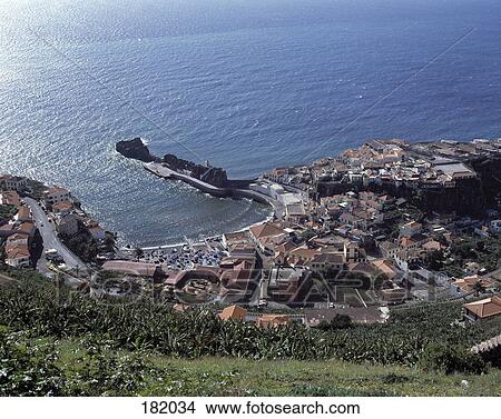 Picture - High angle view of town at coast, Camara De Lobos, Funchal, Madeira Island, Portugal . Fotosearch