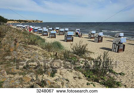 Stock Photo - Hooded beach chairs at the coast of Boltenhagen, Germany . Fotosearch