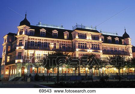Stock Image - Hotel lit up at dusk against blue sky, Ahlbeck, Usedom, Mecklenburg-Western Pomerania, Germany . Fotosearch