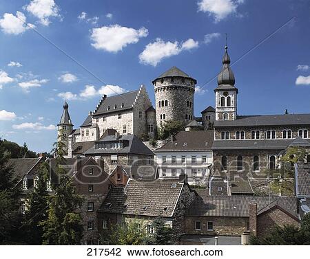 Stock Image - House in front of Parish church, Stolberg, Rheinland, North Rhine-Westphalia, Germany . Fotosearch
