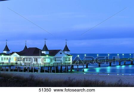 House lit up at dawn on beach, Ahlbeck Pier, Usedom Island, Germany View Large Photo Image Stock Image - House lit up at dawn on beach, Ahlbeck Pier, Usedom Island, Germany . Fotosearch