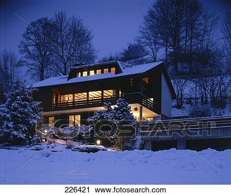 Stock Image - House lit up at night . Fotosearch