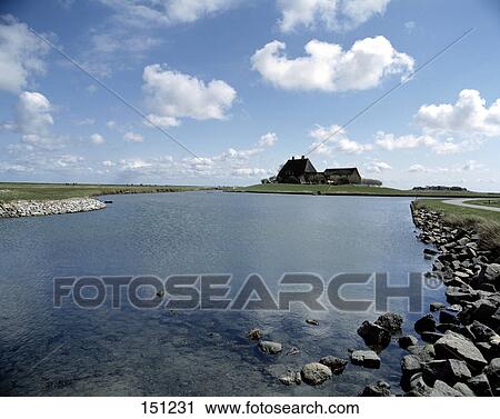 House on a lakeside under cloudy sky, Hallig, North Sea, Schleswig-Holstein, Germany View Large Photo Image Stock Image - House on a lakeside under cloudy sky, Hallig, North Sea, Schleswig-Holstein, Germany . Fotosearch