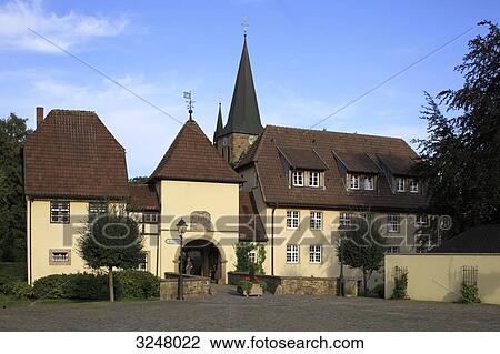 Houses in front of the Saint Vincentius Church in Bersenbrueck, Germany View Large Photo Image Stock Image - Houses in front of the Saint Vincentius Church in Bersenbrueck, Germany . Fotosearch