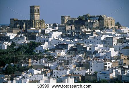 Stock Photo - Houses in town with castle in background, Arcos de la Frontera, Andalusia, Spain . Fotosearch