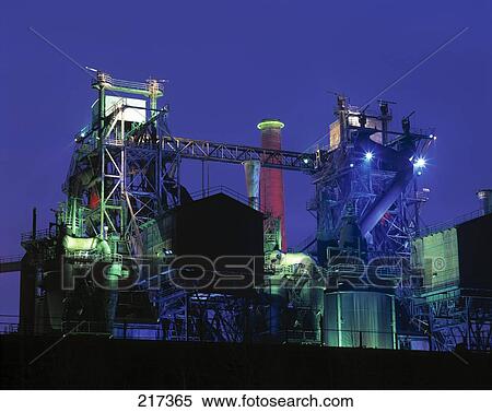 Stock Photography - Installations lit up at dusk in industrial plant . Fotosearch