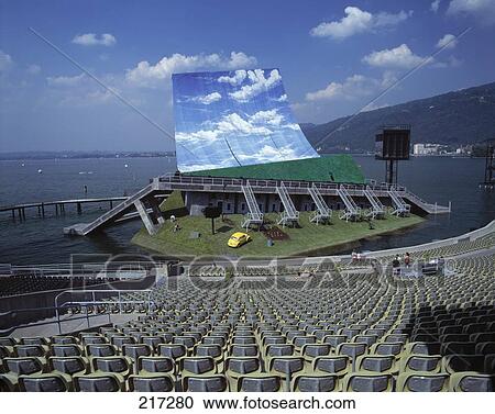 Stock Image - Large screen in open air auditorium on coast, Austria . Fotosearch