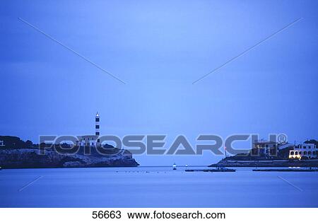 Lighthouse at the coast against blue sky View Large Photo Image Stock Image - Lighthouse at the coast against blue sky . Fotosearch