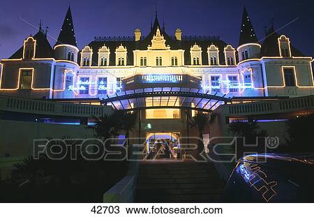 Stock Image - Low angle view of casino lit up at night, Arcachon, France . Fotosearch