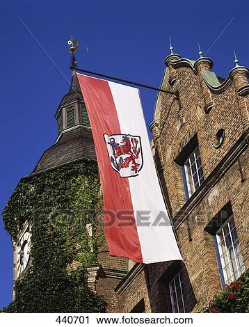 Stock Image - Low angle view of flag mounted in front wall of castle . Fotosearch