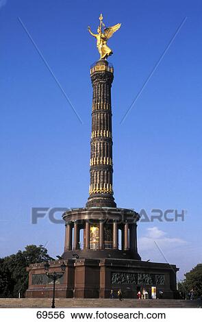 Stock Photograph - Low angle view of gold statue on column, Grosser Stern, Grosser Tiergarten Park, Berlin, Germany . Fotosearch