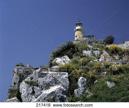 Low angle view of lighthouse on cliff View Large Photo Image Stock Photo - Low angle view of lighthouse on cliff . Fotosearch